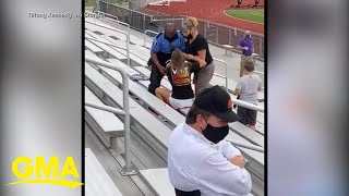 Officer tases arrests woman for not wearing a mask at football game l GMA [upl. by Assed]